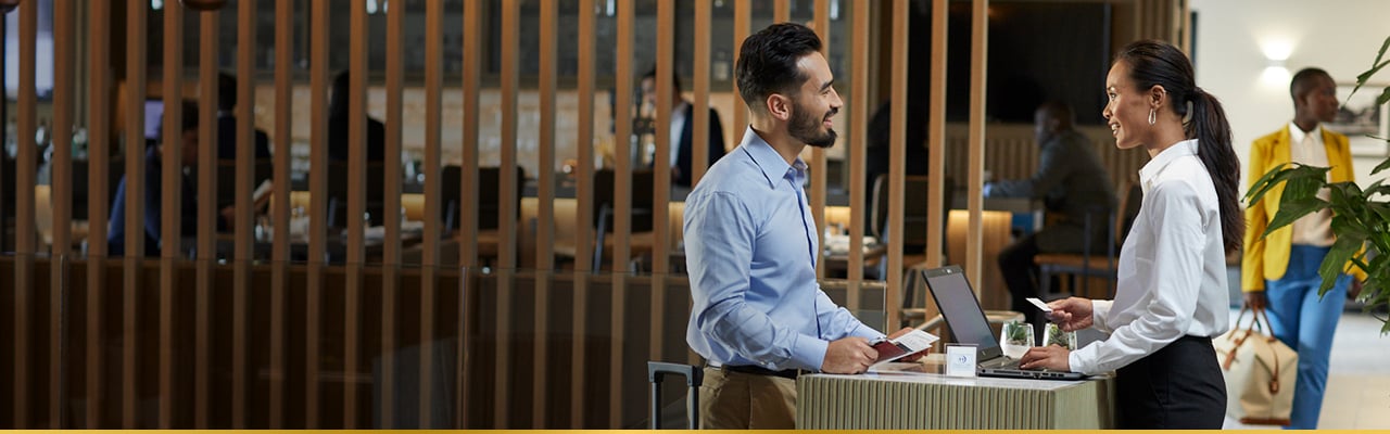 Customer service representative assists a client at a help desk.