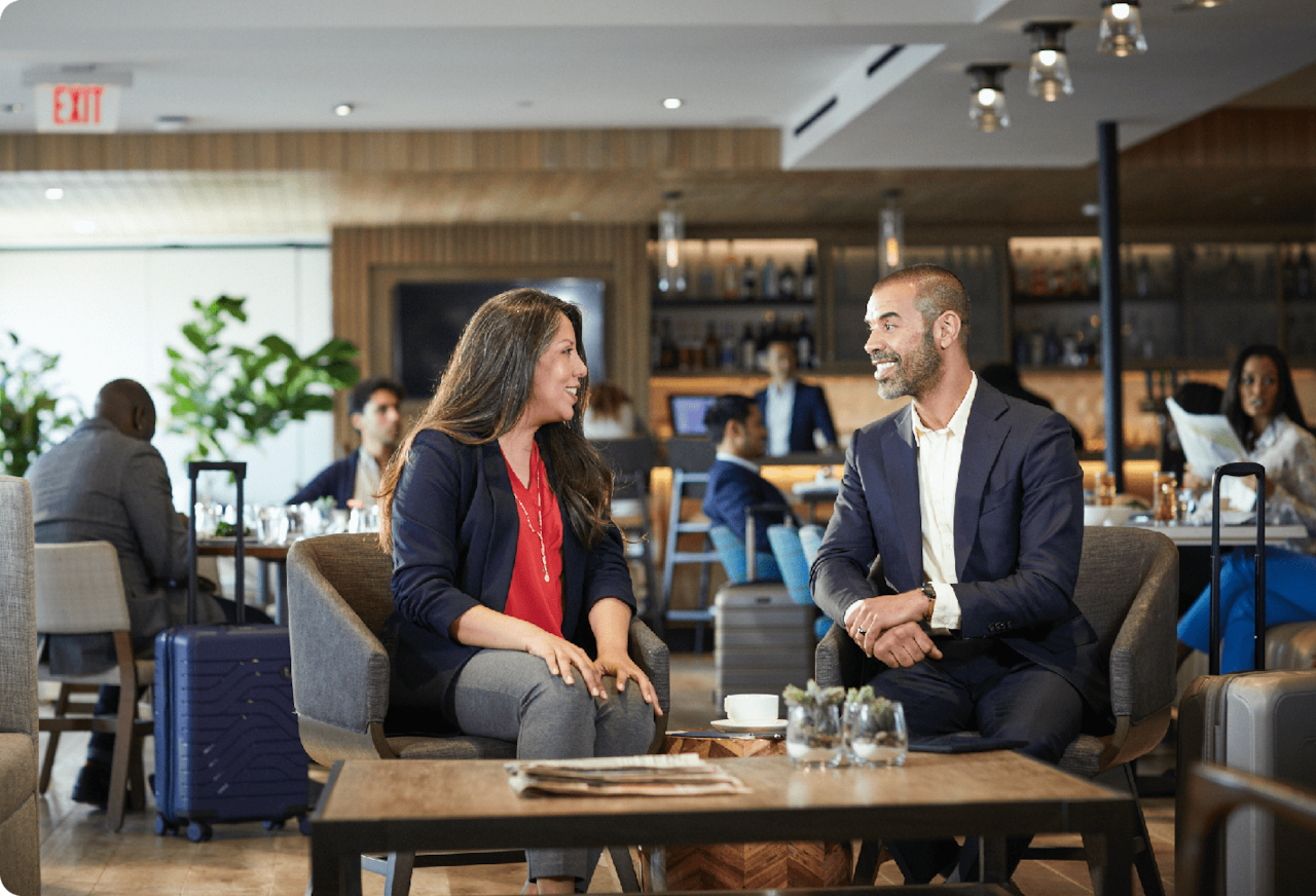 two people speaking in airport lounge